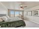 Bright main bedroom featuring a ceiling fan, neutral walls, and plush carpeting under a high ceiling at 23957 E Rocky Top Ave, Aurora, CO 80016