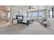Spacious main bedroom with carpet flooring, sitting area, ceiling fan and ensuite bathroom with glass shower at 23957 E Rocky Top Ave, Aurora, CO 80016