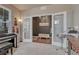 Home office with French doors, black accent wall, and neutral carpeting at 23957 E Rocky Top Ave, Aurora, CO 80016