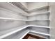 Walk-in pantry with wood floor and multiple shelves offering ample storage at 23957 E Rocky Top Ave, Aurora, CO 80016