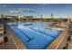 Stunning community pool with lane markers, lounge seating, and pergolas for shade at 23957 E Rocky Top Ave, Aurora, CO 80016