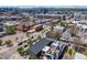 Wide aerial view showing the house within the cityscape and mountain views at 2801 Lawrence St, Denver, CO 80205