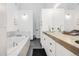 Bright bathroom with modern double sink vanity and a sleek soaking tub at 2801 Lawrence St, Denver, CO 80205