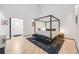 Spacious bedroom features a four poster bed frame, wood floors, and minimalist décor at 2801 Lawrence St, Denver, CO 80205