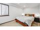 Simple bedroom with window, carpeted floors, and neutral color scheme at 2801 Lawrence St, Denver, CO 80205