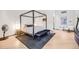 Contemporary bedroom features a four poster bed frame, wood floors, and neutral tones at 2801 Lawrence St, Denver, CO 80205