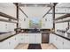 Modern kitchen with ample counter space, white cabinets, and stainless steel appliances at 2801 Lawrence St, Denver, CO 80205