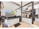 Open kitchen with bar seating, white cabinets, and modern stainless steel dishwasher at 2801 Lawrence St, Denver, CO 80205