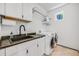 Laundry room with sink, cabinets, washer and dryer at 2801 Lawrence St, Denver, CO 80205