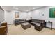 Basement living room with seating, concrete table, and poster art at 2801 Lawrence St, Denver, CO 80205