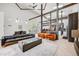 Spacious living room with modern industrial accents, vaulted ceilings, and ample natural light at 2801 Lawrence St, Denver, CO 80205