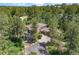 Luxury home nestled in a wooded area with a large driveway at 967 Country Club Pkwy, Castle Rock, CO 80108