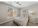 Bright bedroom with large windows, plush bed, and bedside table at 967 Country Club Pkwy, Castle Rock, CO 80108