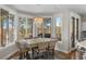 Bright dining area with a table for six, large windows, and access to a deck at 967 Country Club Pkwy, Castle Rock, CO 80108