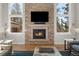 Living room fireplace with stone surround and built-in entertainment center at 967 Country Club Pkwy, Castle Rock, CO 80108