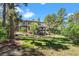Two story home with a landscaped lawn and trees at 967 Country Club Pkwy, Castle Rock, CO 80108