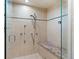 Large walk-in shower with multiple shower heads and a built-in seat at 967 Country Club Pkwy, Castle Rock, CO 80108