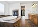 Soaking tub with tile surround and fireplace, and double sink vanity at 5375 Twilight Way, Parker, CO 80134