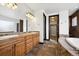 Spacious bathroom featuring a double sink vanity, soaking tub and walk-in closet at 5375 Twilight Way, Parker, CO 80134