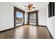 Bedroom with hardwood floors, ceiling fan, and large windows at 5375 Twilight Way, Parker, CO 80134