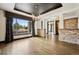 Elegant dining room with large window, stone accents, and chandelier, perfect for entertaining guests at 5375 Twilight Way, Parker, CO 80134