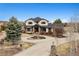 A beautiful two-story home with a circular driveway and stone accents at 5375 Twilight Way, Parker, CO 80134
