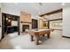Spacious game room features a pool table, stone fireplace, and bar area, perfect for entertaining guests at 5375 Twilight Way, Parker, CO 80134