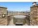 Hot tub built into a stone wall with wrought iron fence and beautiful views at 5375 Twilight Way, Parker, CO 80134