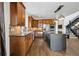 Gourmet kitchen features wood cabinetry, stainless steel appliances, and an island with pendant lighting at 5375 Twilight Way, Parker, CO 80134