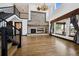 Bright, two-story living room with hardwood floors, stone fireplace, and large windows at 5375 Twilight Way, Parker, CO 80134