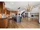 Open-concept living space with stone fireplace and hardwood floors, seamlessly connecting to the kitchen at 5375 Twilight Way, Parker, CO 80134