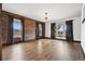 Bright and airy living room with wood-paneled wall and large windows offering scenic views at 5375 Twilight Way, Parker, CO 80134