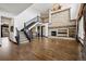 Spacious living room boasts soaring ceilings, hardwood floors, and a cozy stone fireplace at 5375 Twilight Way, Parker, CO 80134