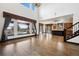 Open concept living room with hardwood floors, lots of light, and views of the backyard pool at 5375 Twilight Way, Parker, CO 80134