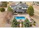 Overhead aerial showcases an inviting in-ground pool, hot tub, patio, and built-in kitchen area at 5375 Twilight Way, Parker, CO 80134
