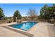 Beautiful backyard pool with stone surround, fence, and professionally designed landscaping at 5375 Twilight Way, Parker, CO 80134