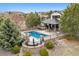 Aerial view of a stunning in-ground pool with a stone-surround and well-manicured landscaping at 5375 Twilight Way, Parker, CO 80134