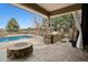 Backyard with a custom outdoor kitchen, inground pool, and stone fire pit at 5375 Twilight Way, Parker, CO 80134