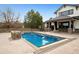 View of pool and outdoor entertaining space with custom stone work, fire pit, and covered porch at 5375 Twilight Way, Parker, CO 80134