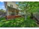 Relax on this backyard deck with lovely views of the green lawn and mature trees at 8944 W 66Th Pl, Arvada, CO 80004