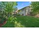Expansive backyard with a lush lawn, mature trees, and a charming outdoor patio area at 8944 W 66Th Pl, Arvada, CO 80004