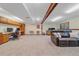 Spacious basement with a leather sofa, built in desk, and lots of natural light at 8944 W 66Th Pl, Arvada, CO 80004