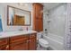 Bathroom featuring a tub and shower combination and a vanity with ample storage at 8944 W 66Th Pl, Arvada, CO 80004