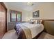 Comfortable bedroom with a large window and neutral decor at 8944 W 66Th Pl, Arvada, CO 80004