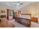 Comfortable bedroom with vaulted ceiling, natural light, and wooden furniture at 8944 W 66Th Pl, Arvada, CO 80004