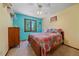 Cheerful bedroom with blue accent wall, colorful bedding, and ceiling fan at 8944 W 66Th Pl, Arvada, CO 80004