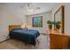 Comfortable bedroom with a bed, window, ceiling fan and plant decoration at 8944 W 66Th Pl, Arvada, CO 80004