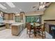 Open kitchen and dining area with large windows that provide beautiful wooded views at 8944 W 66Th Pl, Arvada, CO 80004