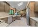 Bright kitchen features stainless steel appliances, quartz countertops, and seamless dining space at 8944 W 66Th Pl, Arvada, CO 80004