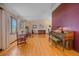 Bright living room with hardwood floors, tall windows and piano at 8944 W 66Th Pl, Arvada, CO 80004
